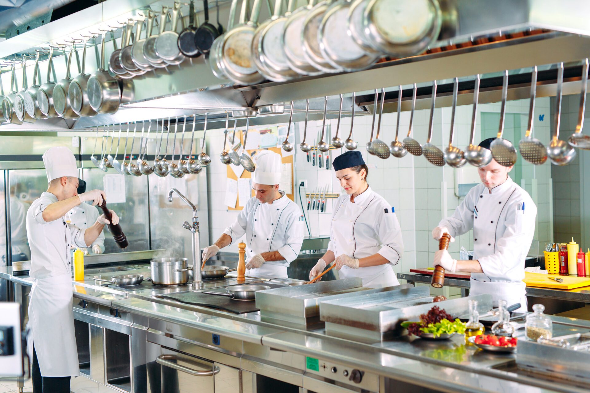 Modern kitchen. Cooks prepare meals on the stove in the kitchen of the restaurant or hotel. The fire in the kitchen.